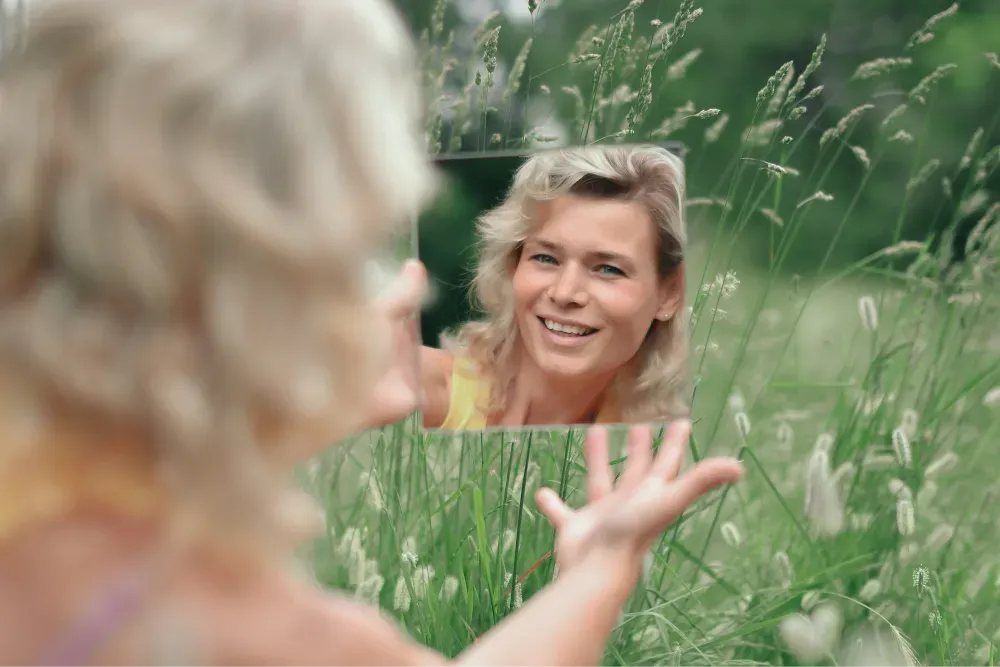 woman in green grass field during daytime