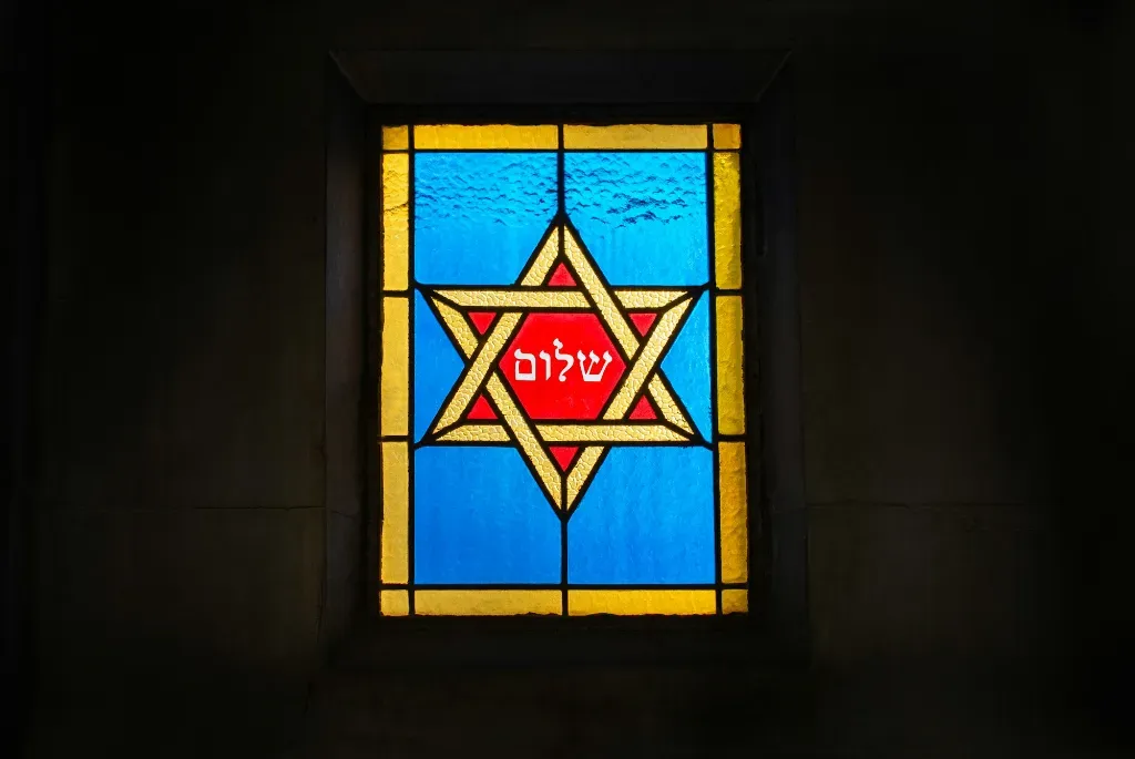 a stained glass window with a star of david on it